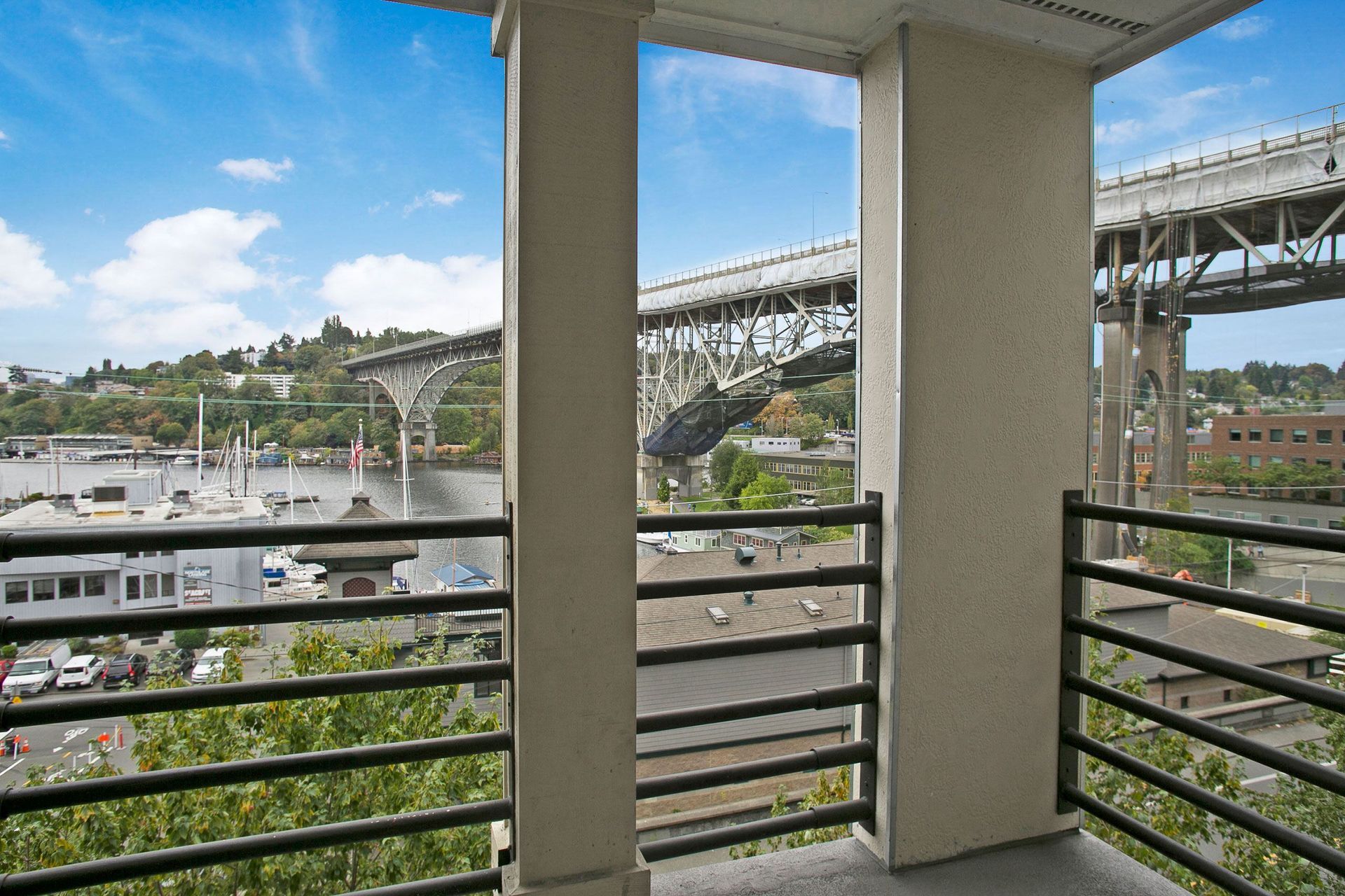A balcony with a view of a bridge over a body of water.
