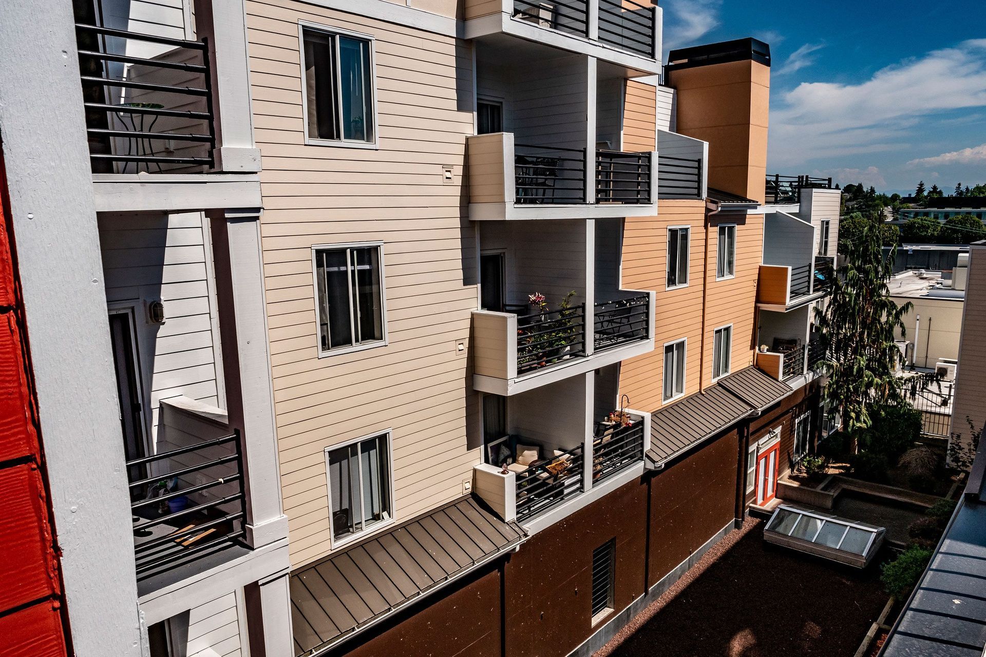 An aerial view of a large apartment building with balconies.