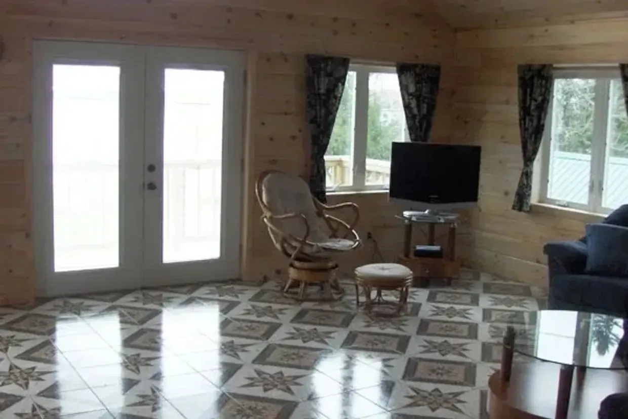 a living room with a couch a chair and a television