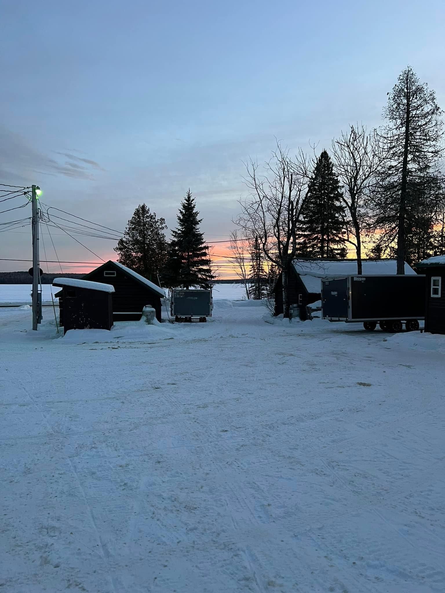 a snowy area with a sunset in the background