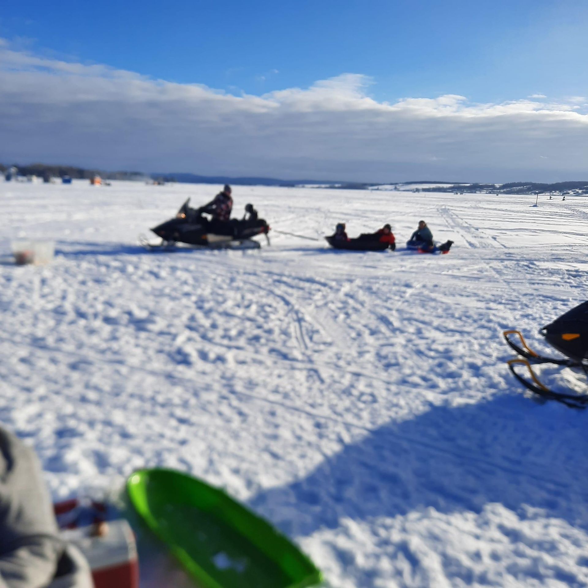 a group of people riding snowmobiles in the snow
