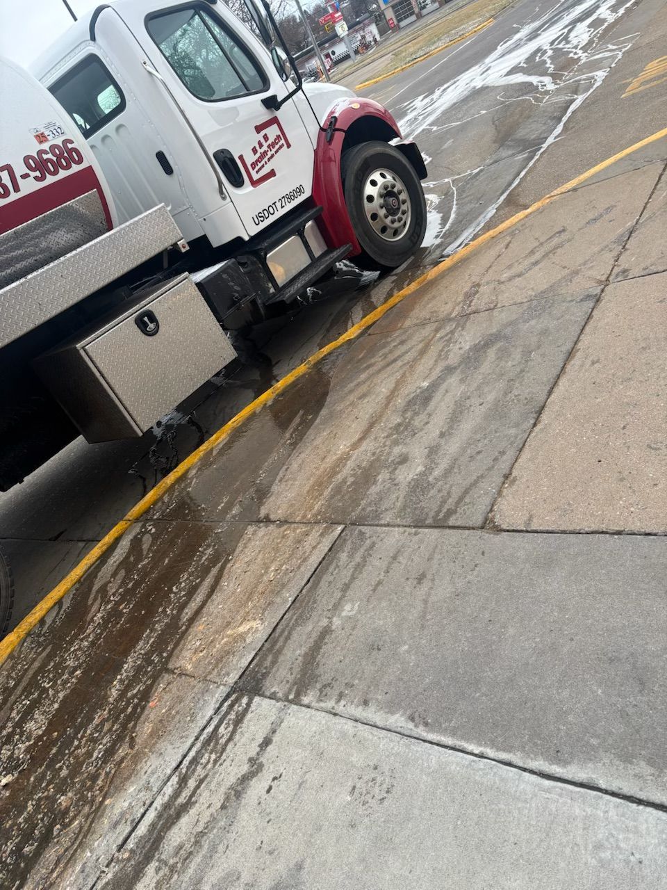 A tow truck is parked on the side of the road