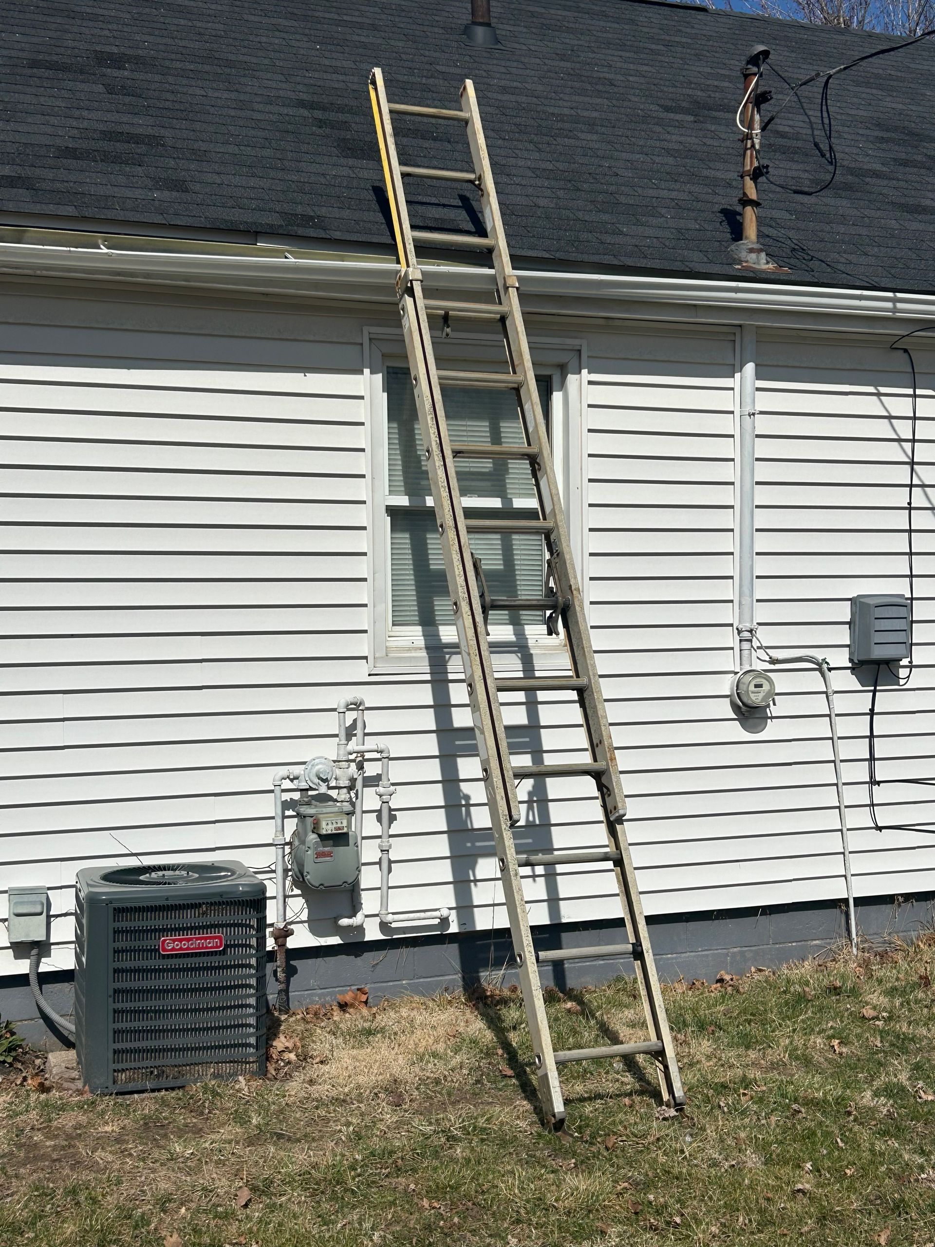 A ladder is leaning against the side of a house