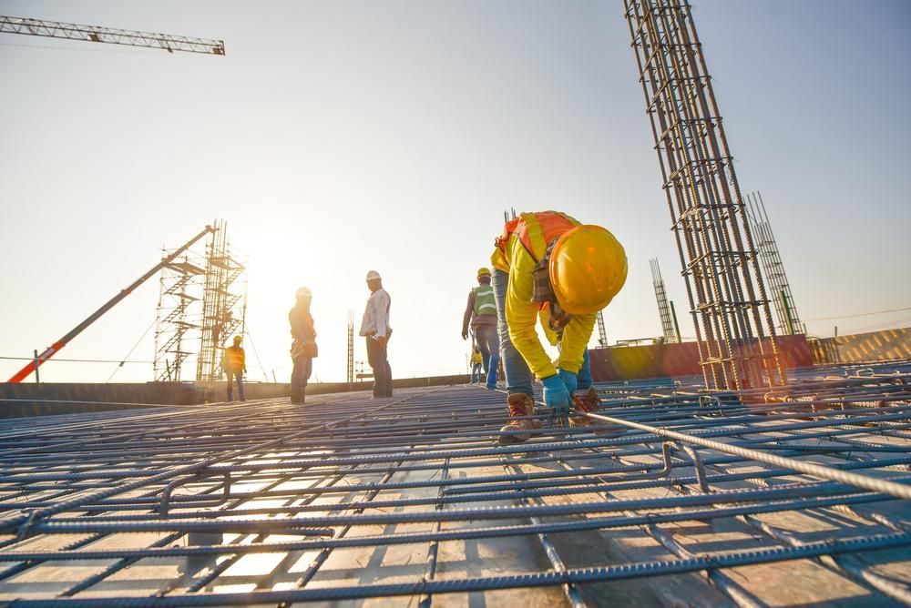 A Group of Construction Workers Are Working on a Construction Site — Young Building In Forster, NSW