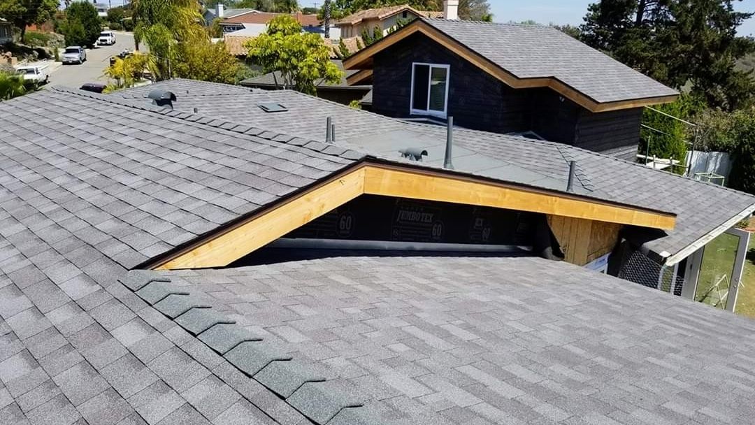 An aerial view of a house with a new roof.