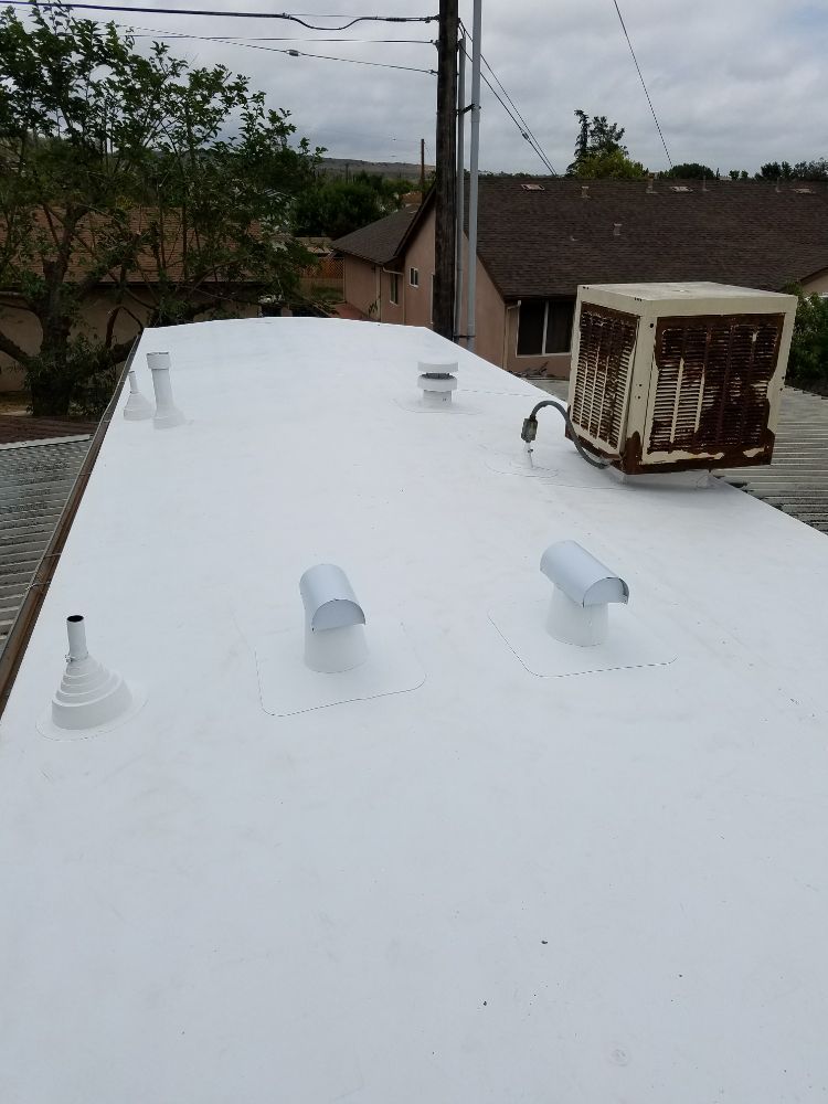 A white roof with a fan on top of it.