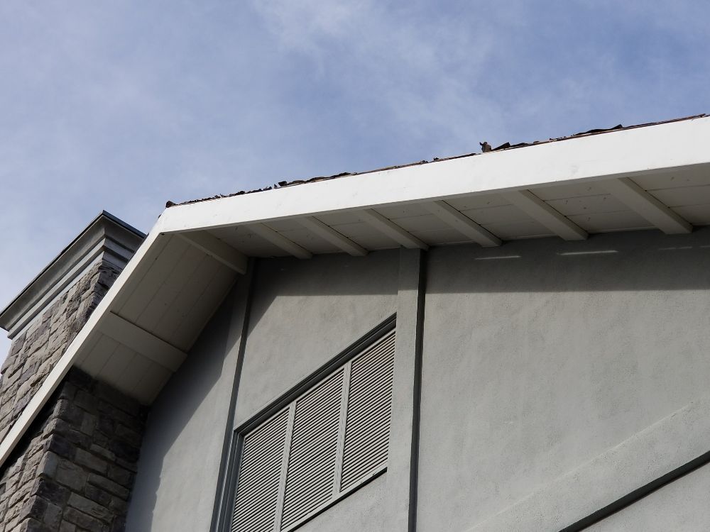 Looking up at the roof of a building with a chimney
