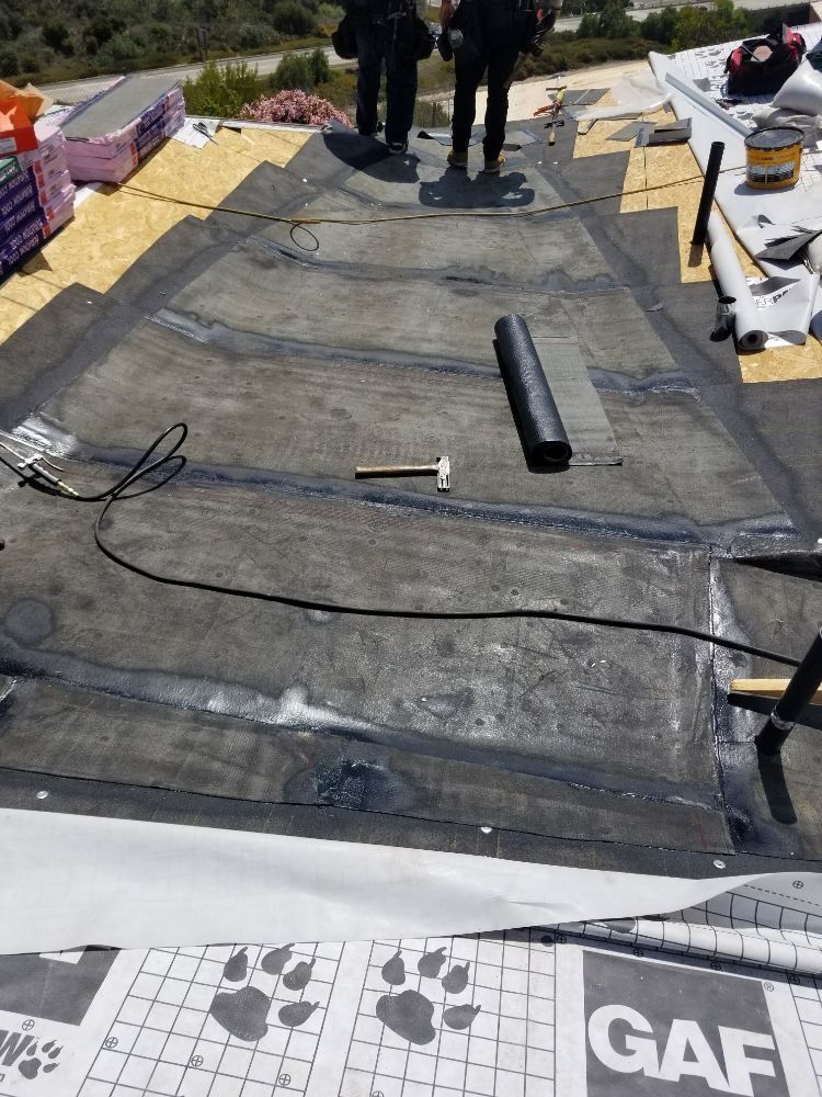 A roof is being installed with a hammer and a tape measure