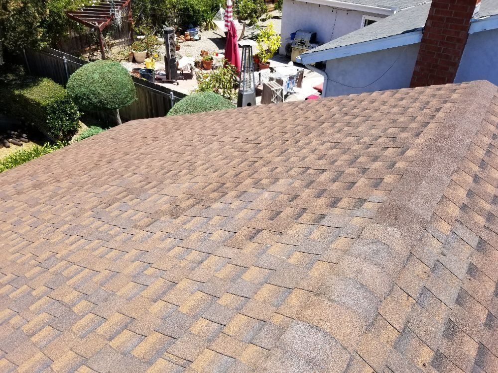 The roof of a house has a lot of shingles on it