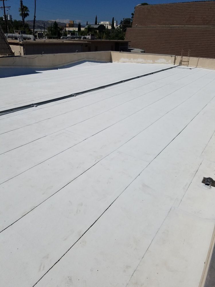 A white roof is being installed on top of a building.
