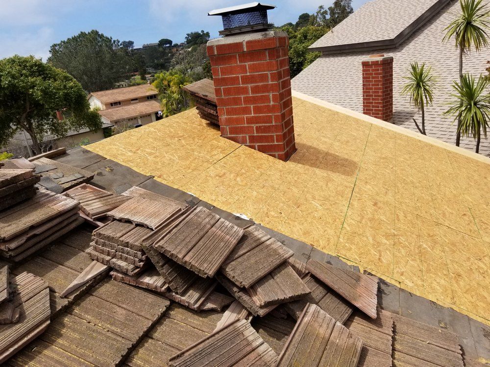 A roof with a brick chimney on top of it