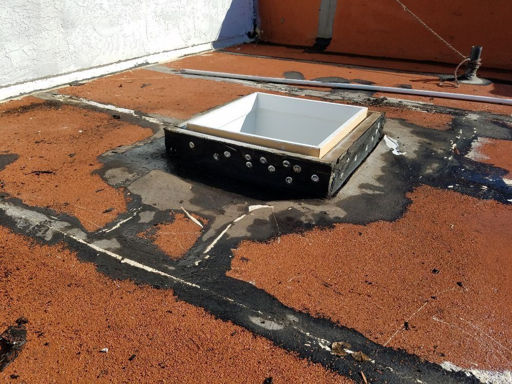 A roof with a skylight in the middle of it