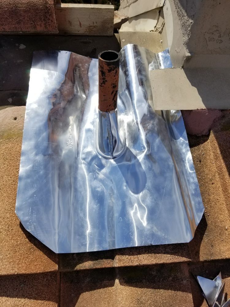 A metal pipe is sitting on top of a piece of aluminum foil.