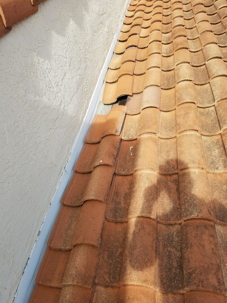 A close up of a roof with a shadow of a person on it.