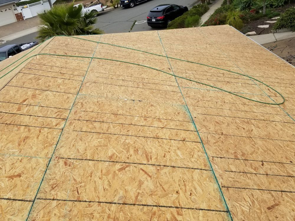 A roof with a lot of plywood on it is being built.