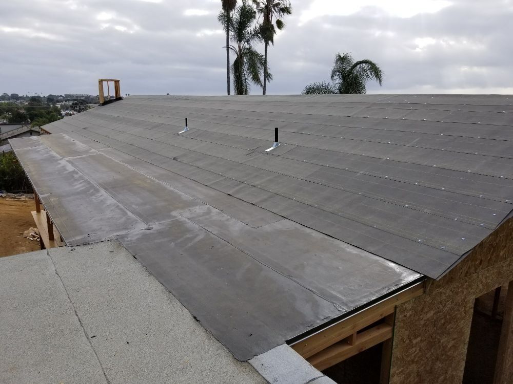 A roof with a few trees in the background