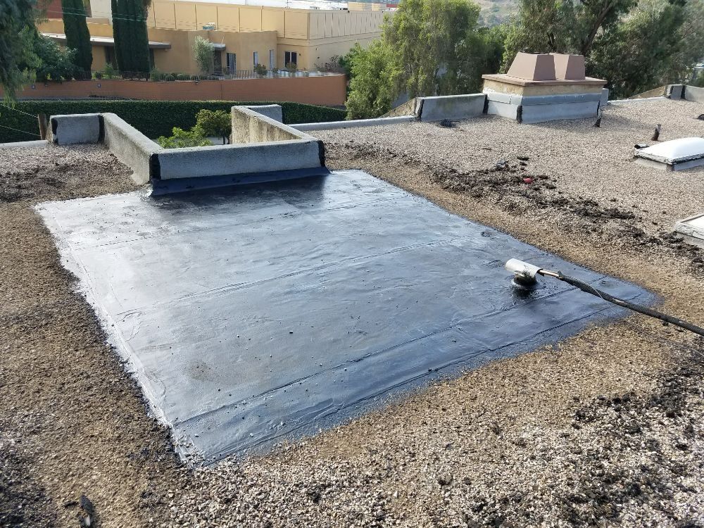 A roof with a black roof coating on it
