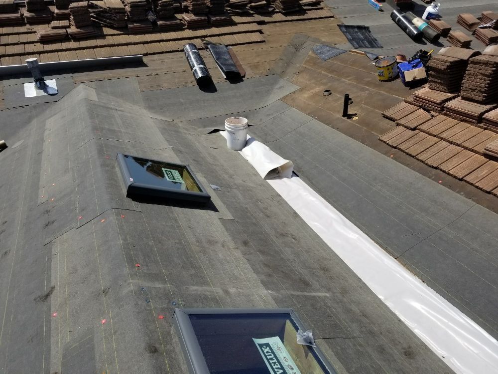 An aerial view of a roof with skylights and a sign that says solar