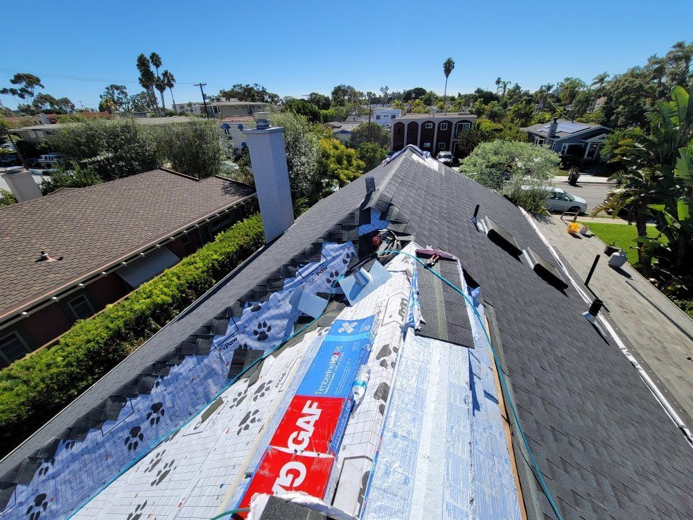 An aerial view of a roof that is being repaired