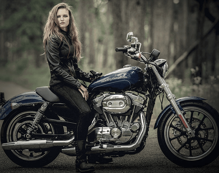 Young women riding Harley Davidson 