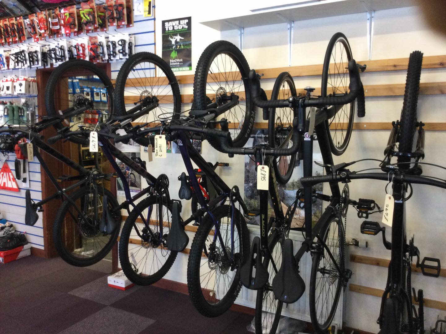 a bunch of bicycles are hanging on a rack in a store