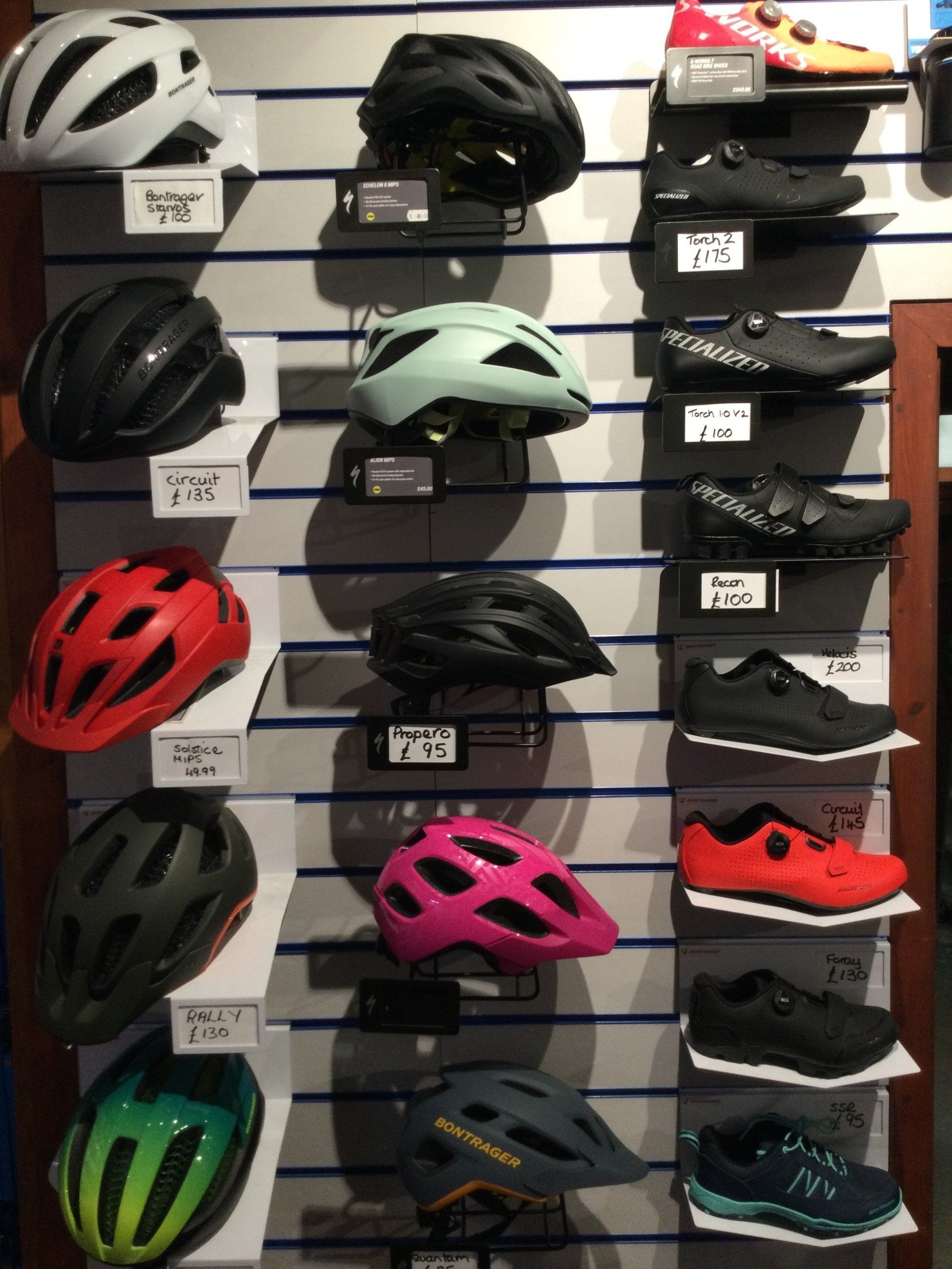 a display of bicycle helmets and shoes including a bontrager helmet