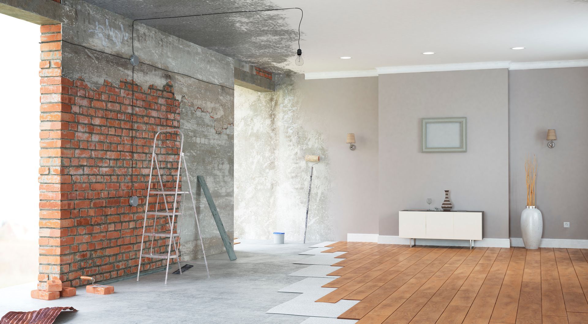 Partially renovated room with exposed brick, concrete wall, and wood floor beside a white cabinet and vase