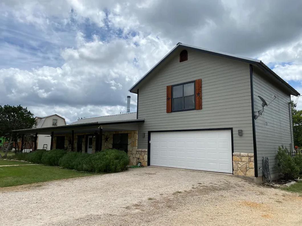 A large house with a garage and a driveway in front of it.