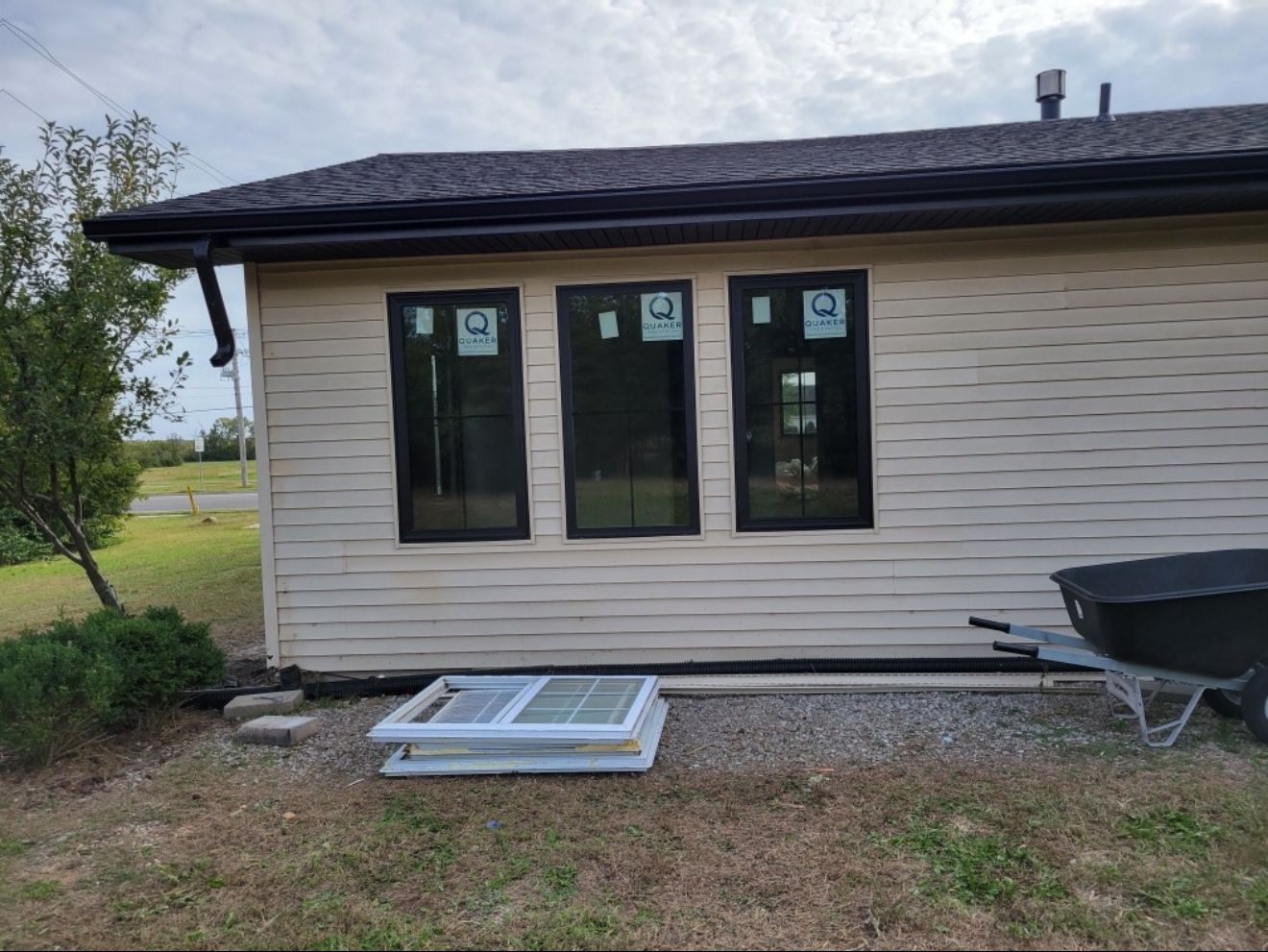 Exterior view of a building with three black-framed windows