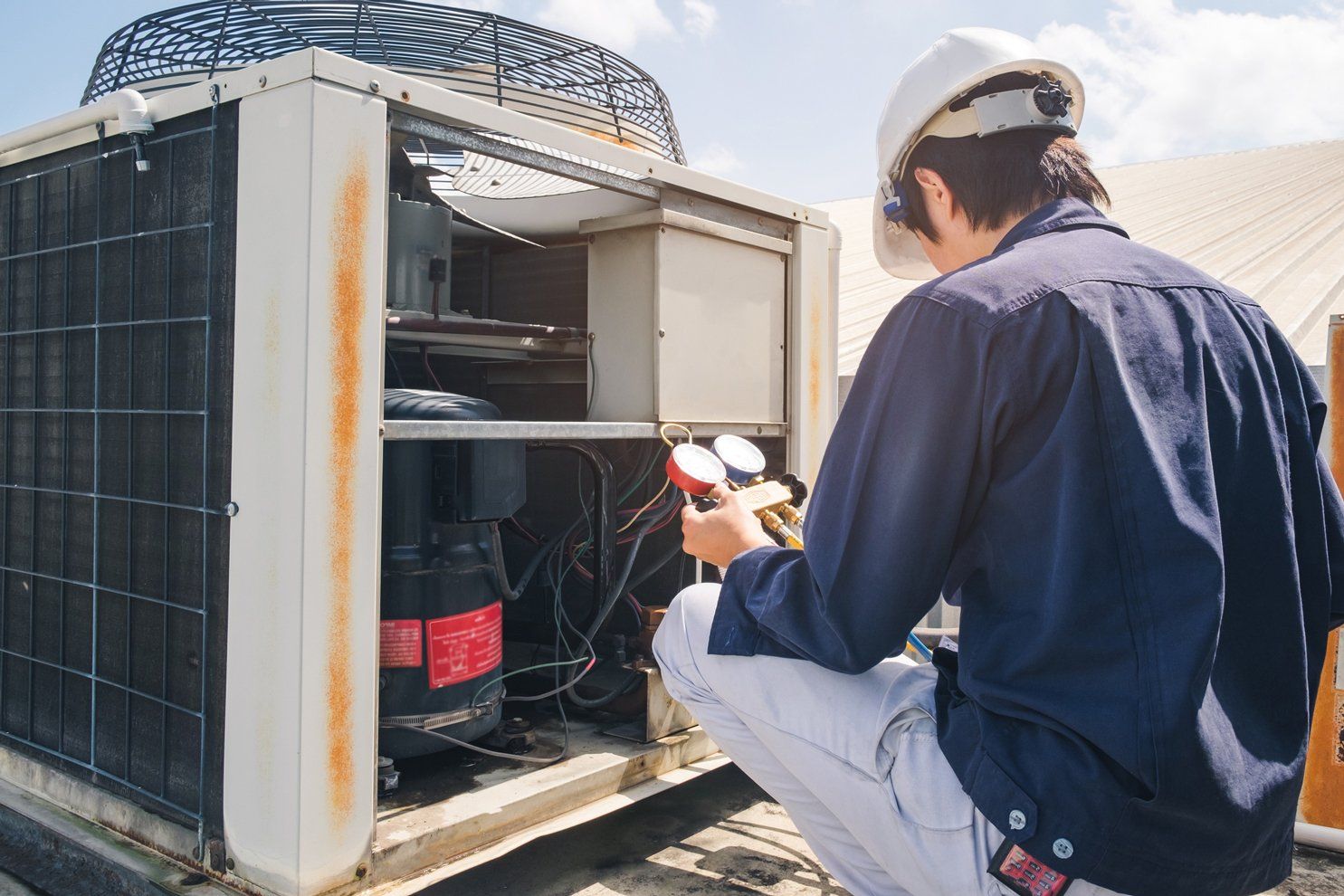 Technician Checking Air Conditioner — Newcastle, NSW — Impact Air & Electrical PTY LTD