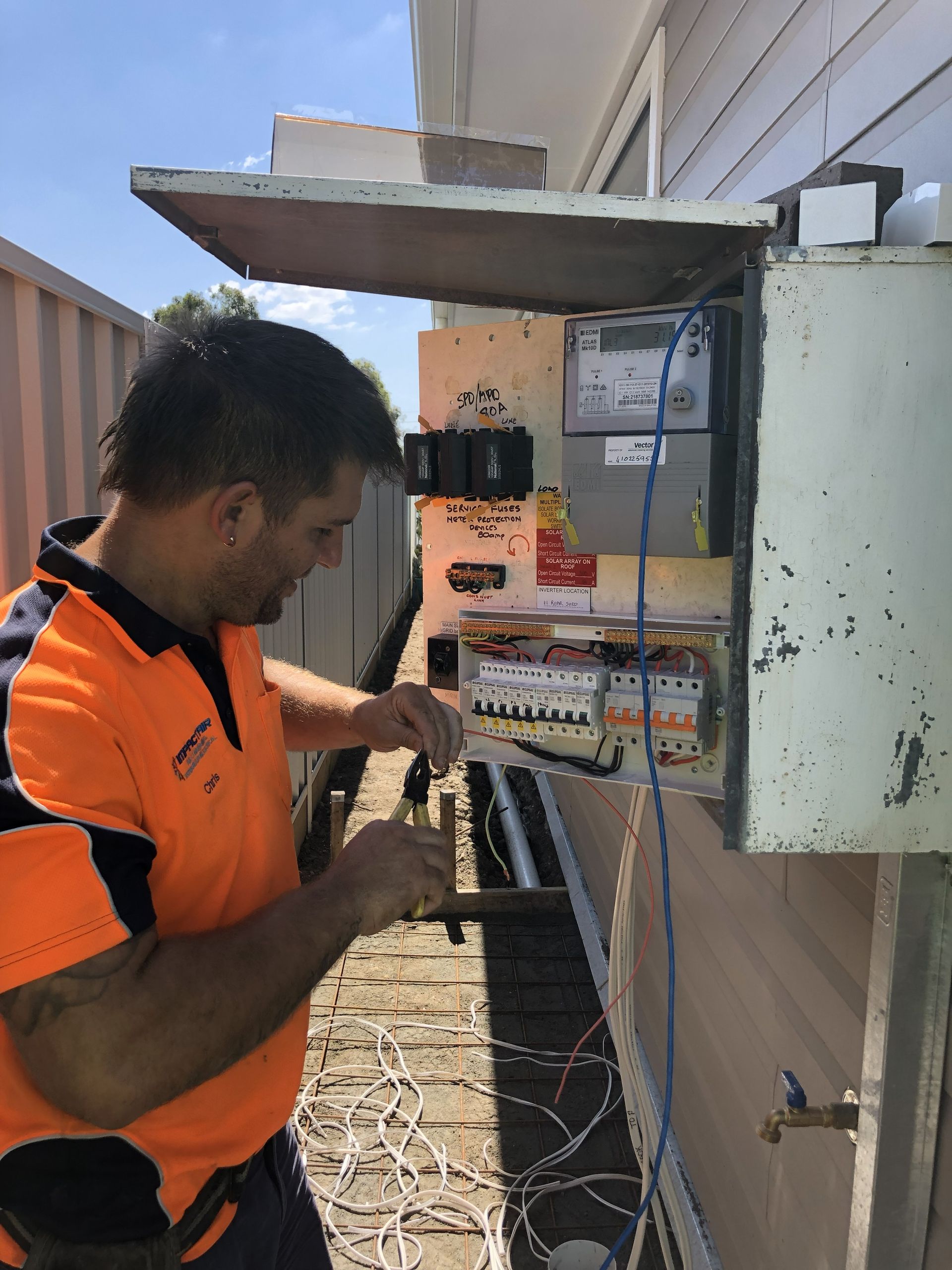 Technician Checking Air Conditioner — Newcastle, NSW — Impact Air & Electrical PTY LTD Technician Checking Air Conditioner — Newcastle, NSW — Impact Air & Electrical PTY LTD