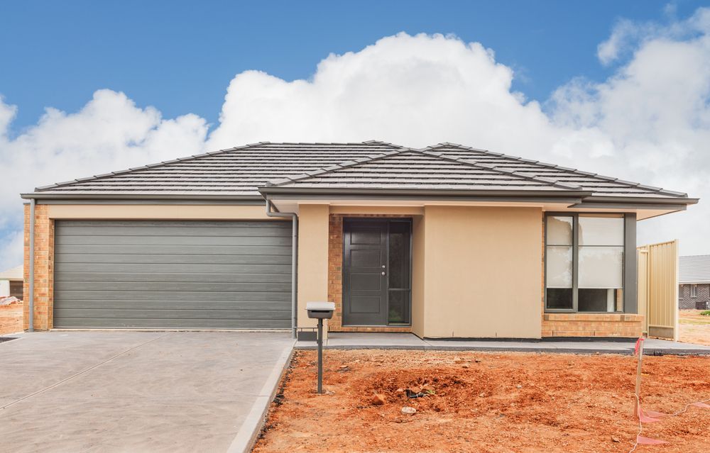 A House With a Garage and a Mailbox in Front of It — Sheps Roofing Service Pty Ltd In Kiama, NSW