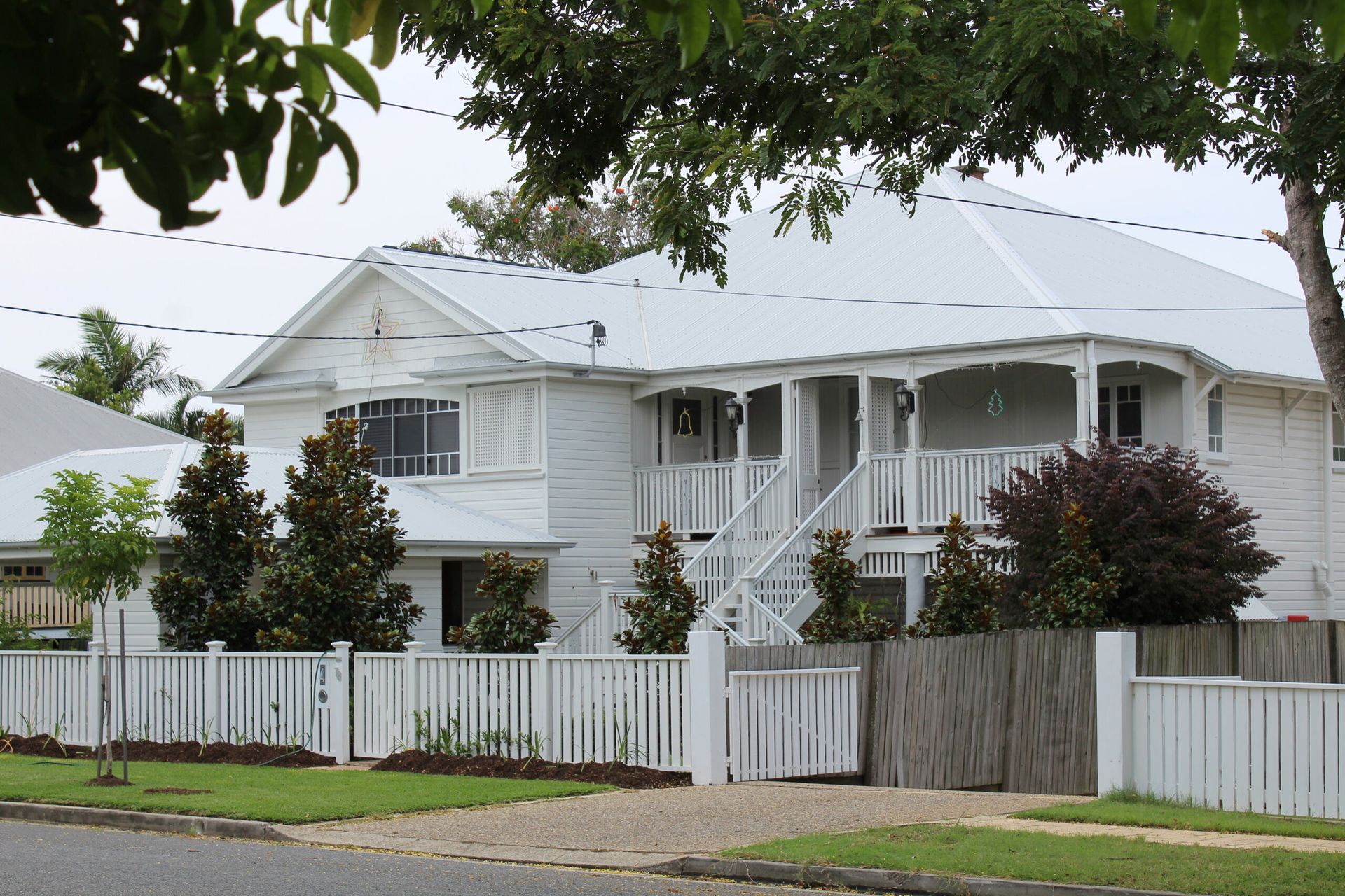 A White House With a Porch and a White Fence — Sheps Roofing Service Pty Ltd In Gerrigong, NSW