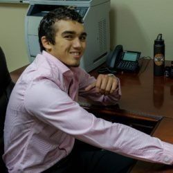 Austin Clark, sitting at a desk.

