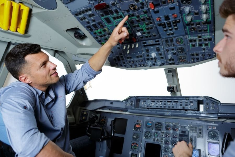 a certified flight instructor and a student pilot in the cockpit of an airplane