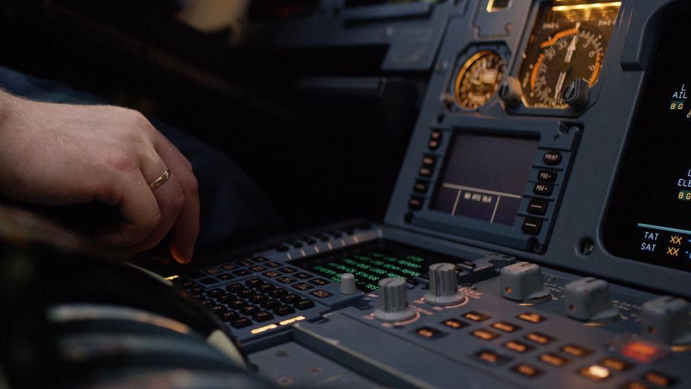 A panel of switches on an aircraft flight deck.