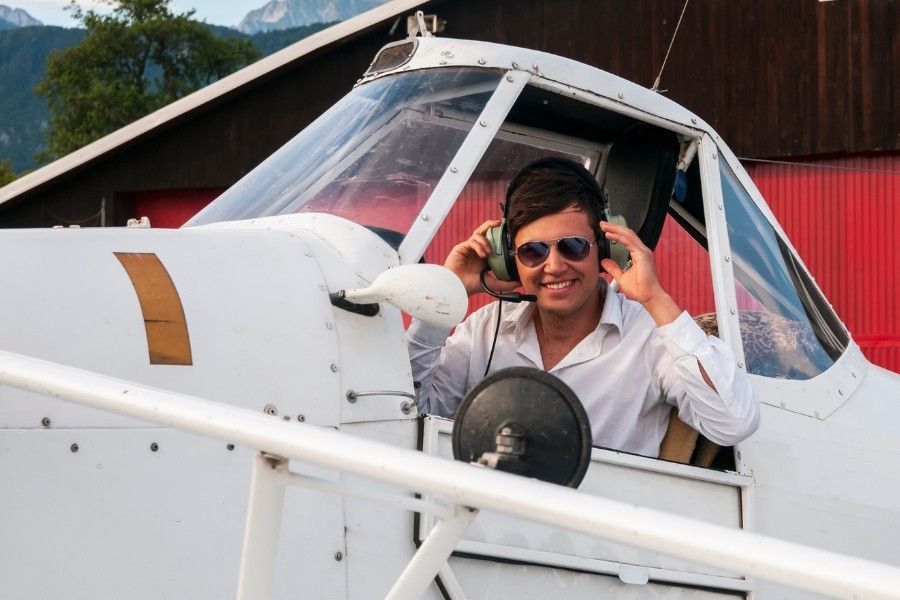 a student pilot sitting in a plane who was able to get financing for tuition