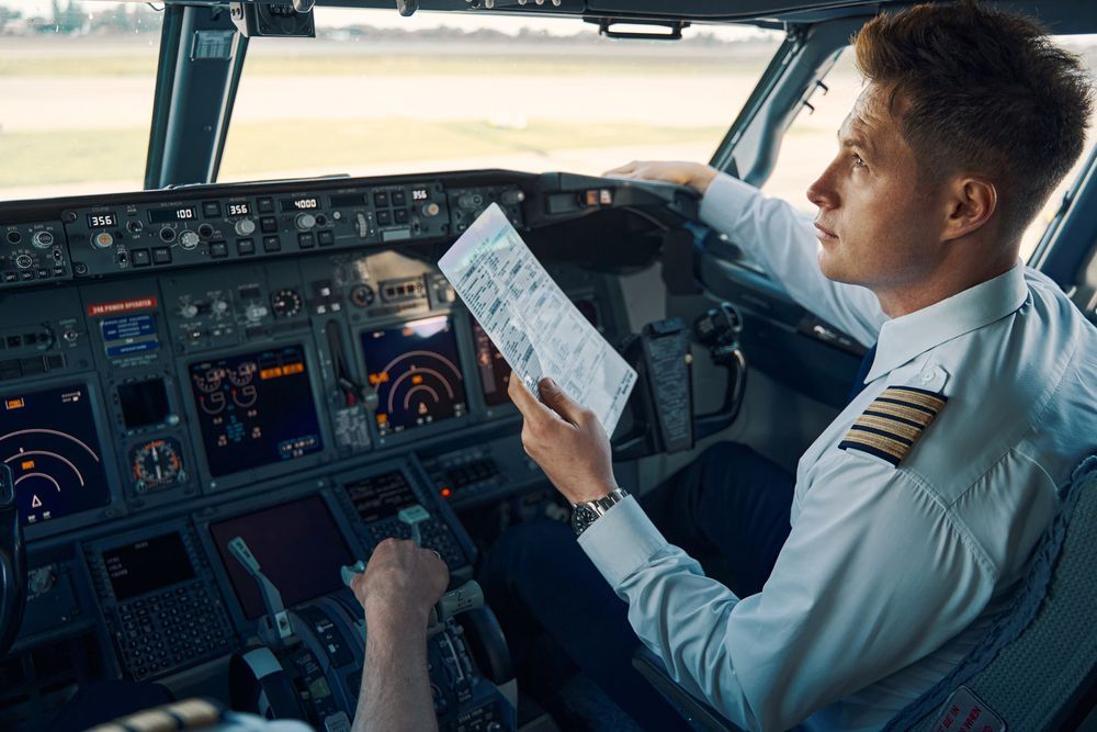 a airline pilot sitting in the cock pit
