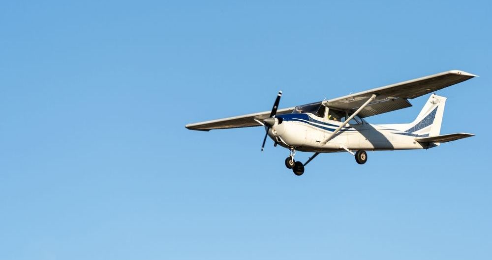 small aircraft flying in the air demonstrating roll pitch and yaw 