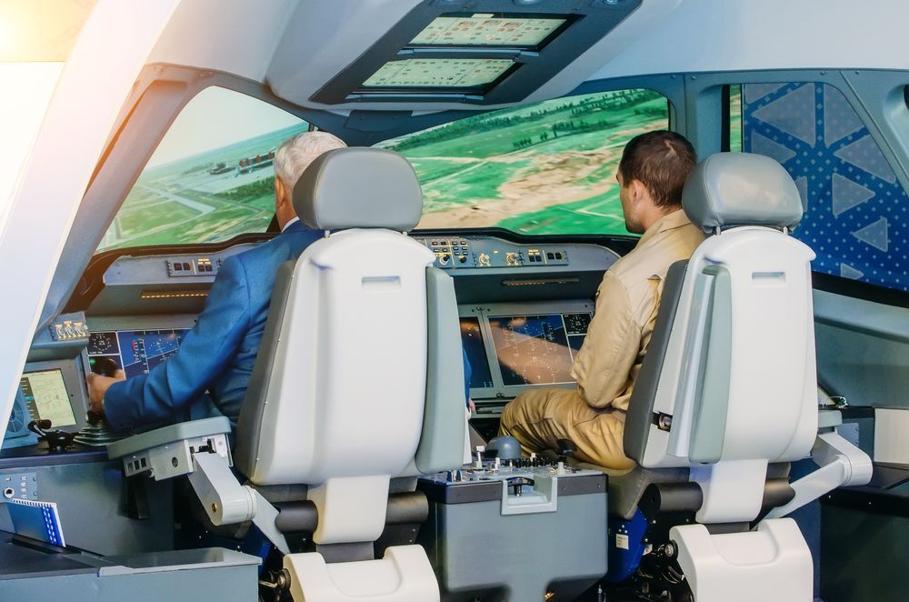 Two pilots are sitting in the cockpit of an airplane.