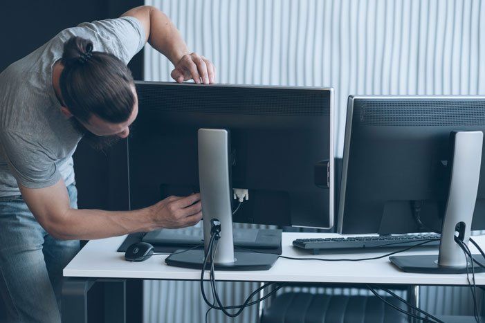 Man Installing A Monitor — Morehead City, NC — On-Site Computing Tech, LLC