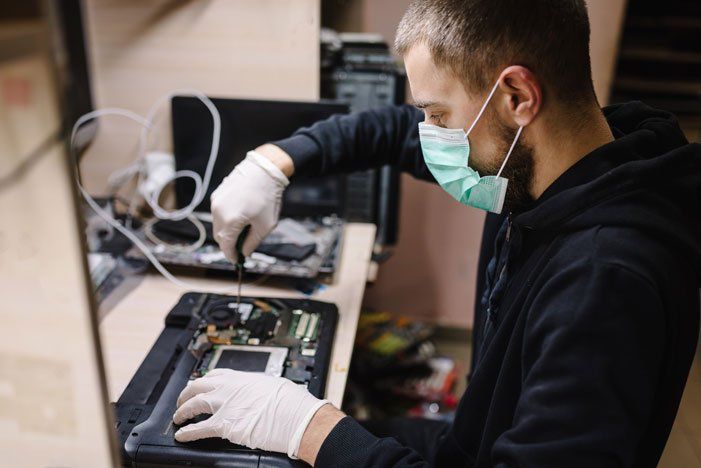 Man Doing A Laptop Computer Inspection — Morehead City, NC — On-Site Computing Tech, LLC