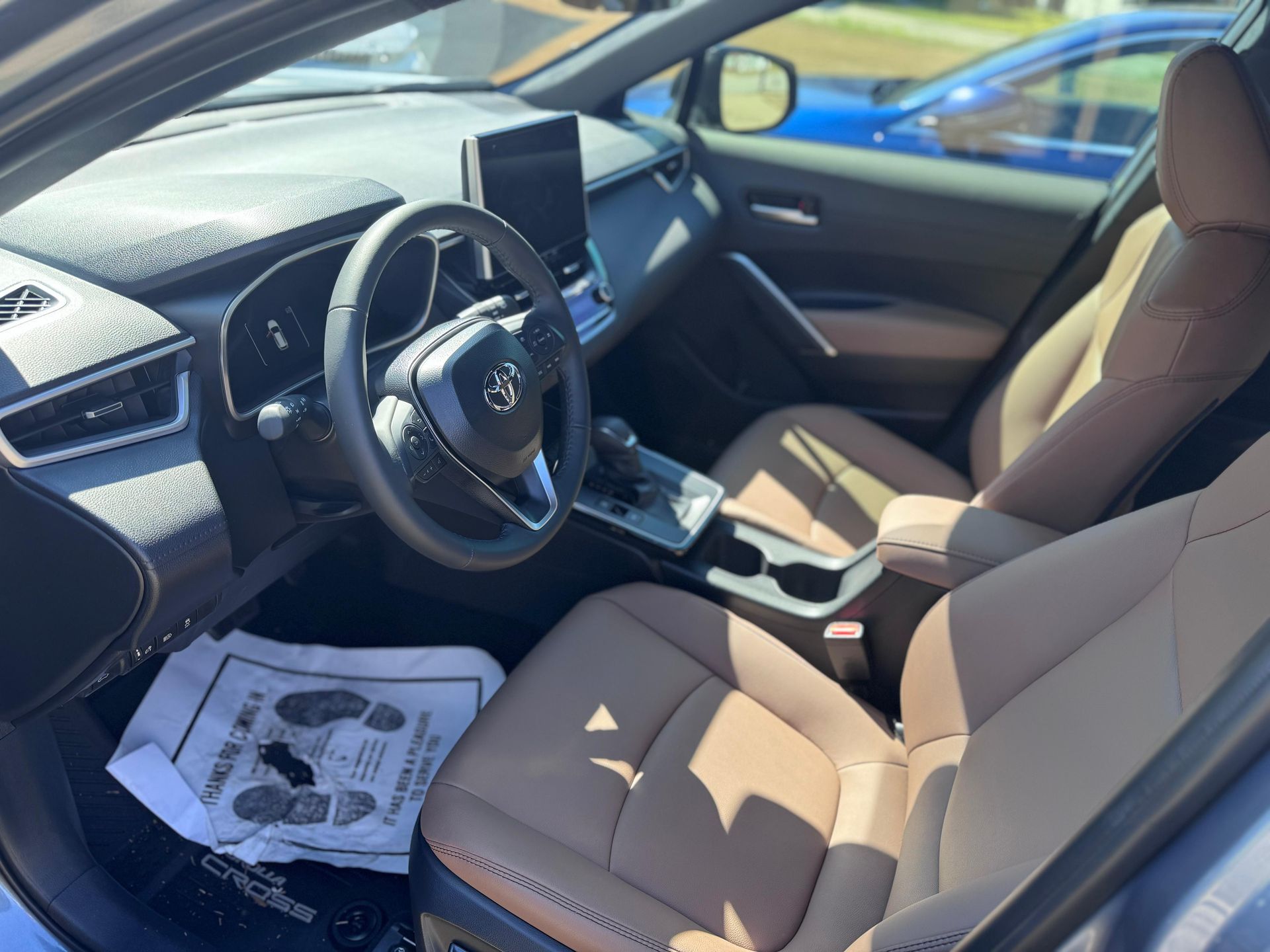 A black Nissan Maxima and a dark blue Mercedes-Benz sedan parked side-by-side on a residential concrete driveway.