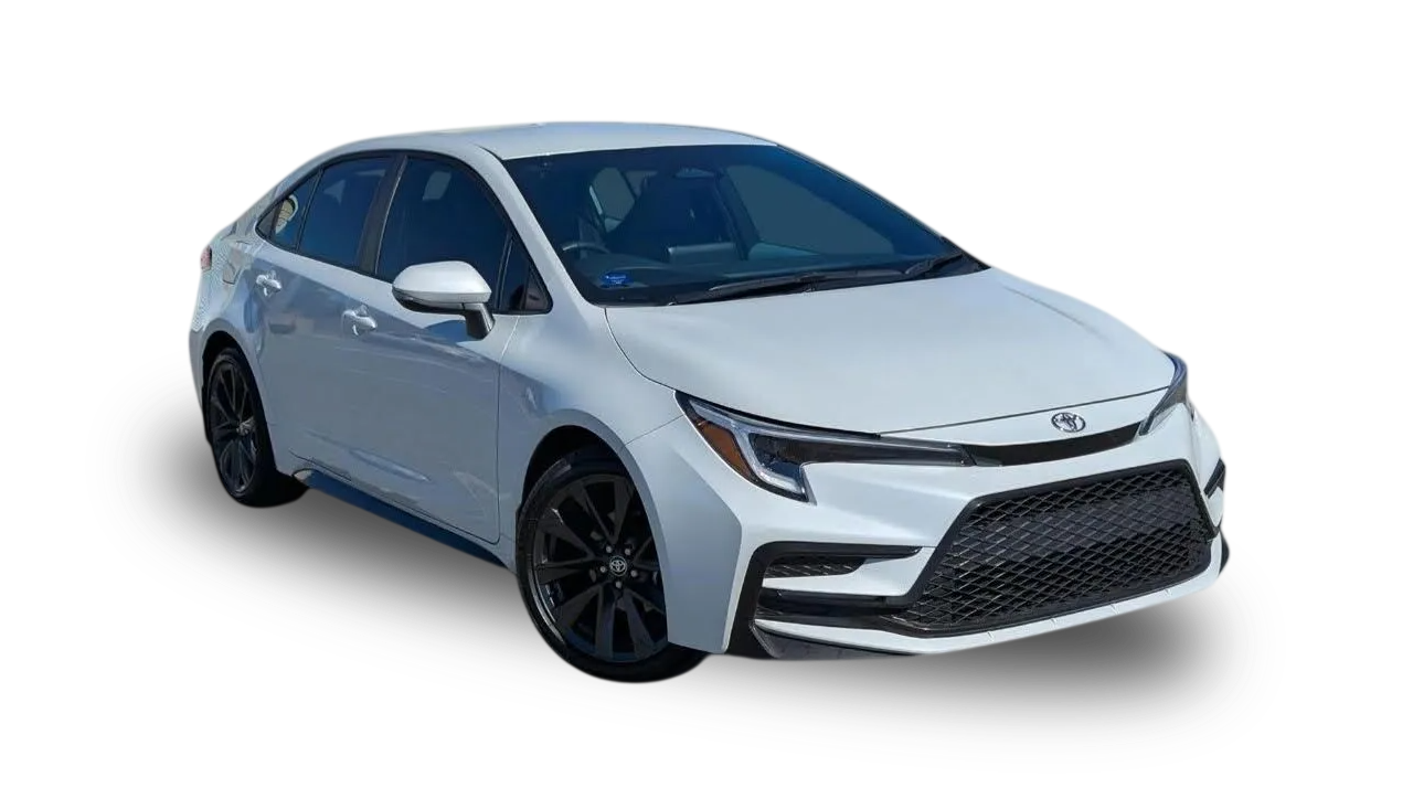 Rear view of a dark gray Nissan Maxima parked on a residential driveway.