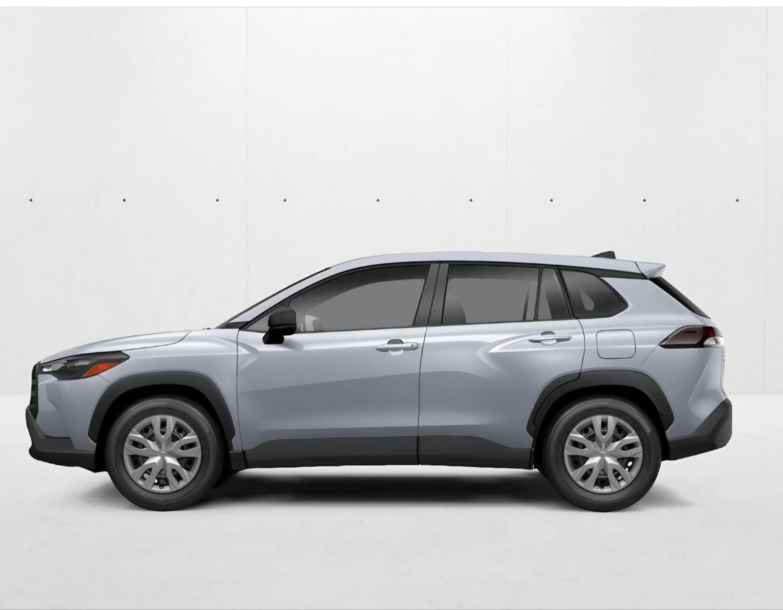 A silver Toyota Corolla Cross SUV viewed from the side against a plain white background.