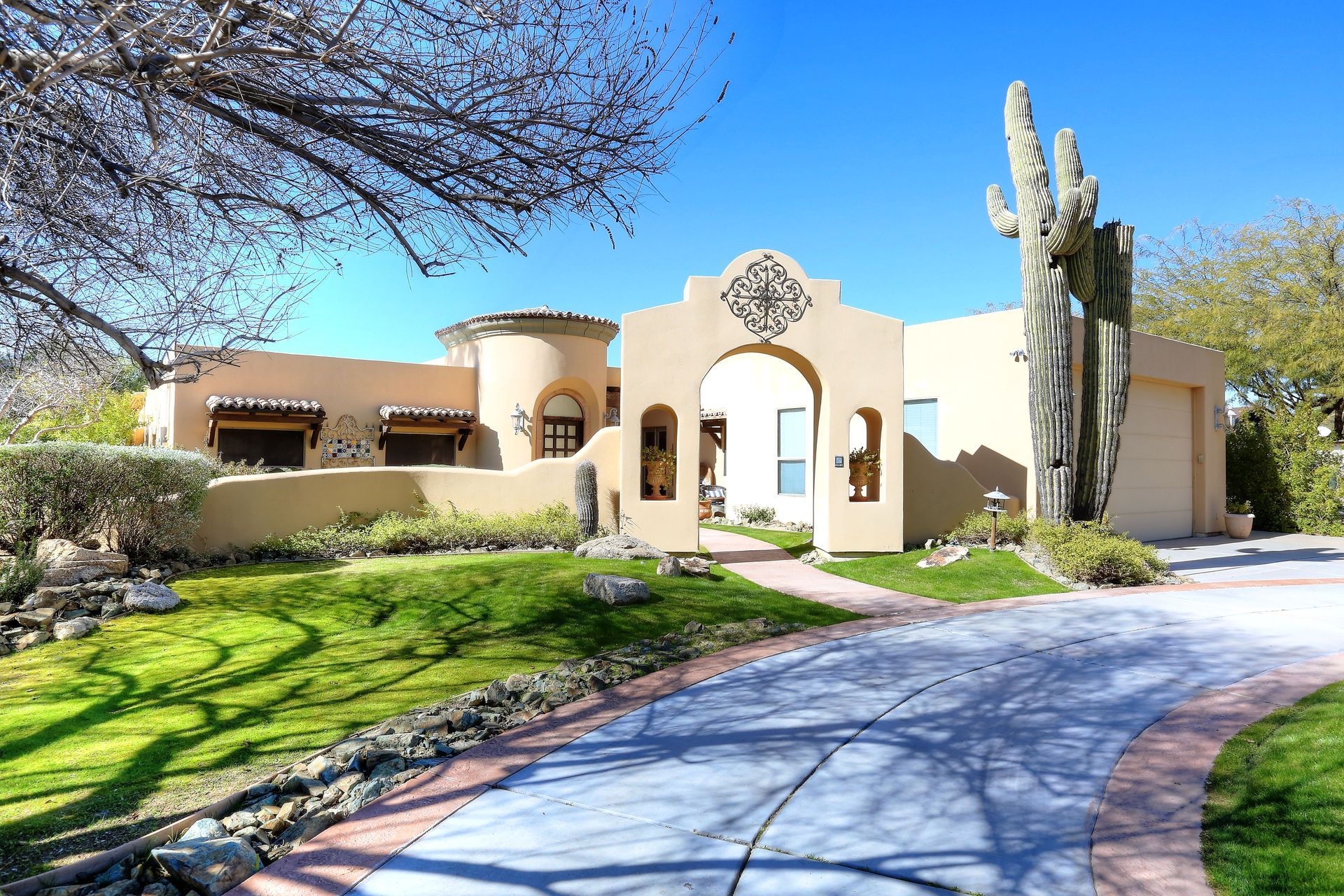 A large house with a cactus in front of it