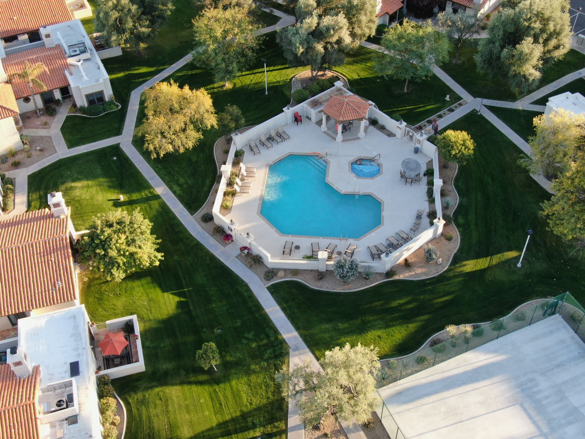 An aerial view of a swimming pool in a residential area