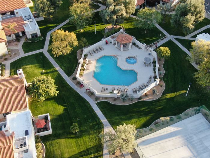 An aerial view of a swimming pool in a residential area