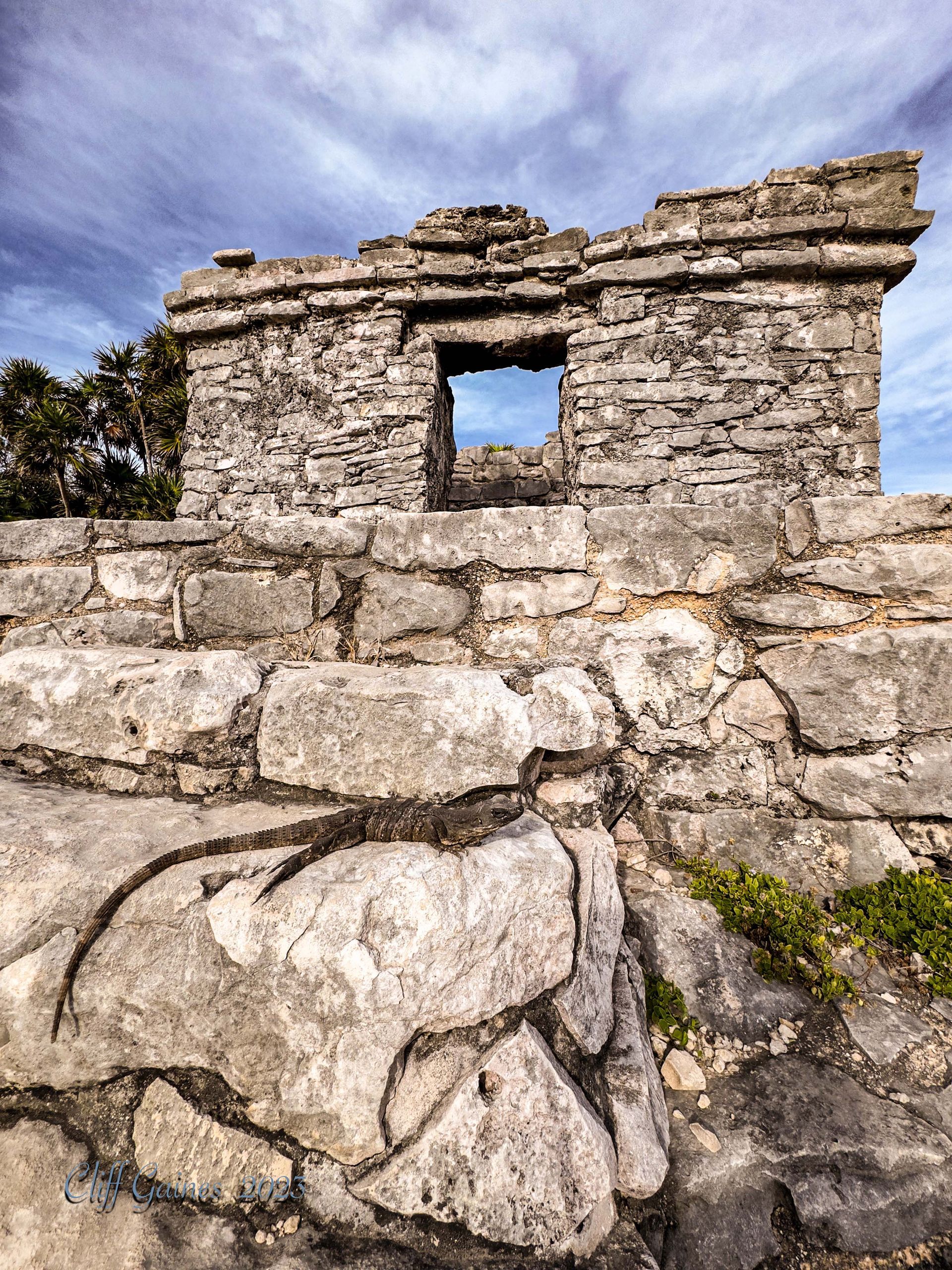 A stone building with a window in the middle of it.