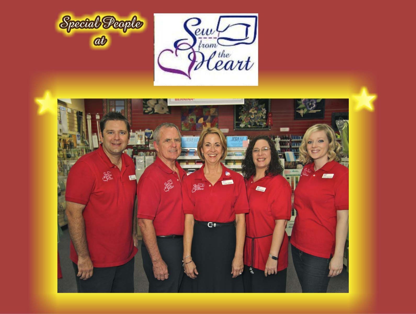 A group of people standing in front of a sign that says sew the heart